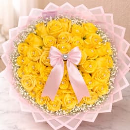 Bouquet of yellow roses with a pink ribbon and baby’s breath