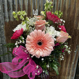 Pink gerbera bouquet with roses and white daisies in a vase