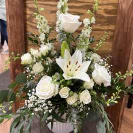 White rose and lily arrangement in a white vase