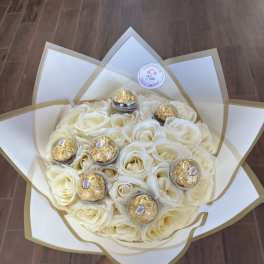 Bouquet of white roses with gold-wrapped chocolates