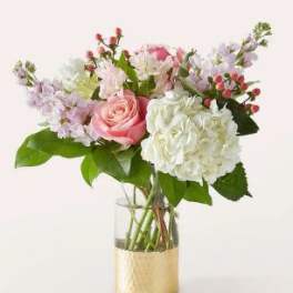 Pink and white bouquet in a gold vase