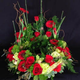 Large red floral arrangement with roses and gerbera daisies