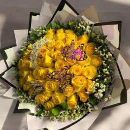 Bouquet of yellow roses with butterfly decorations and decorative wrap