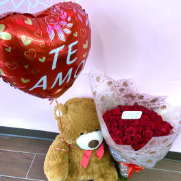 Teddy bear with a red heart balloon and bouquet of red roses