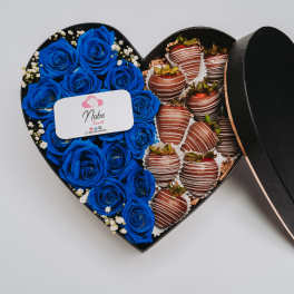 Heart-shaped box with blue roses and chocolate-covered strawberries
