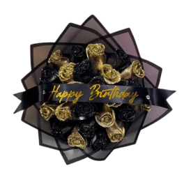 Bouquet of black and gold roses wrapped in dark paper with a Happy Birthday ribbon