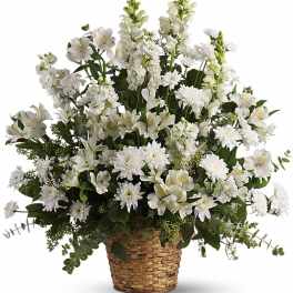 Fan-shaped arrangement of white flowers in a woven basket