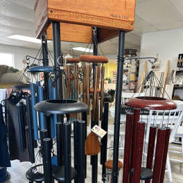 Hanging metal wind chimes in blue, black, and red finishes