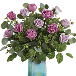 Pink and lavender roses in a blue glass vase
