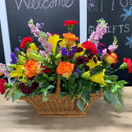 Colorful mixed flower arrangement in a wicker basket
