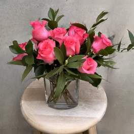 Pink roses arranged in a clear glass vase