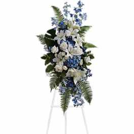 White and blue funeral spray on a standing easel