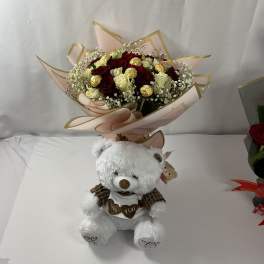 Bouquet of red and white roses with a teddy bear below