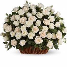 Large basket arrangement of ivory and white roses tightly clustered in a fan shape