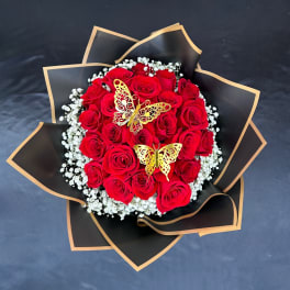 Bouquet of red roses with white baby's breath and gold butterfly accents