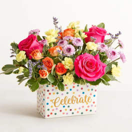 Bright mixed bouquet in a polka-dot box with "Celebrate" text