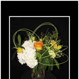Bouquet of white hydrangeas and orange-yellow roses in a glass vase