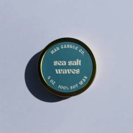 Round candle tin labeled "sea salt waves"