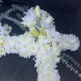 White floral cross arrangement with lilies and chrysanthemums