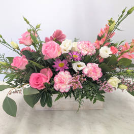 Pink and white mixed flower arrangement in a rectangular wooden box