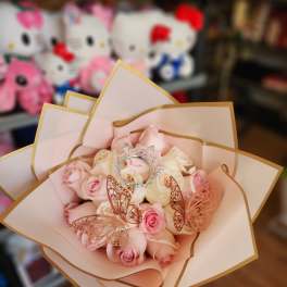 Bouquet of pale pink and cream roses with butterfly decorations