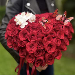 Heart-shaped bouquet of red roses with white orchids and butterfly picks
