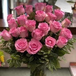 Pink roses arranged in a clear glass vase
