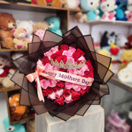 Bouquet of red and pink roses with a crown and Mother's Day ribbon
