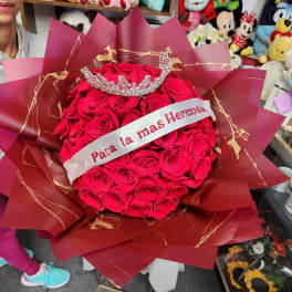 Bouquet of red roses with a jeweled crown and ribbon