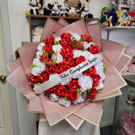 Red and white rose bouquet with a birthday ribbon and butterfly accents