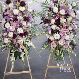 Two large standing floral sprays with pink, white, and purple blooms