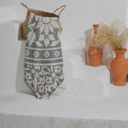Decorative wall display with woven basket, patterned textile, and terracotta vases