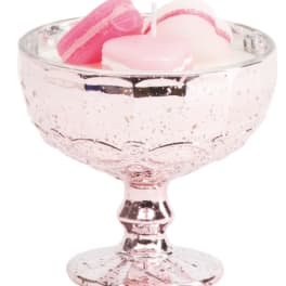 Pink glass pedestal bowl holding pastel macarons