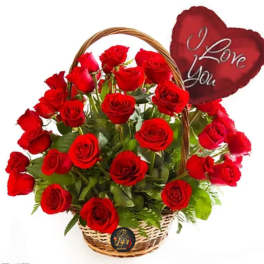 Basket of red roses with a heart-shaped "I Love You" sign