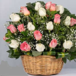 Pink and white roses in a wicker basket