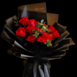 Bouquet of red roses wrapped in black paper