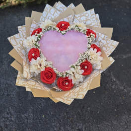 Heart-shaped bouquet with red and white flowers and pink center