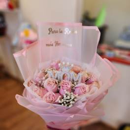 Pink rose bouquet with a jeweled MOM topper and pink wrap