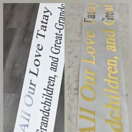 Two printed memorial ribbons with text honoring children and grandchildren.