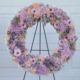 Large pastel floral wreath on a black stand