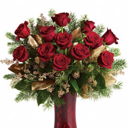 Red roses arranged in a burgundy vase with gold accents