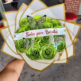 Bouquet of bright green roses with butterfly decorations and a ribbon