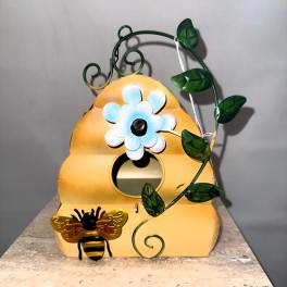 Decorative bee house with a painted flower and vine design