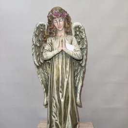 Decorative angel statue with floral crown and folded hands