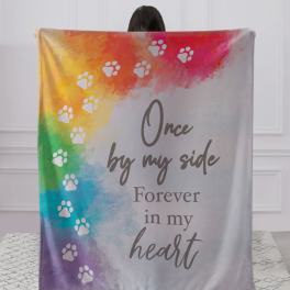 Rainbow memorial blanket with paw prints and the words "Once by my side Forever in my heart"
