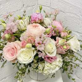 Pink and white mixed bouquet in a striped metal vase