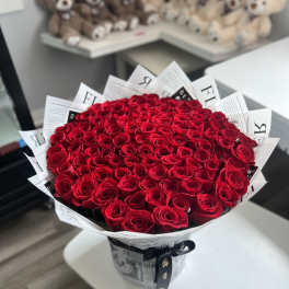 Large bouquet of red roses wrapped in black-and-white paper