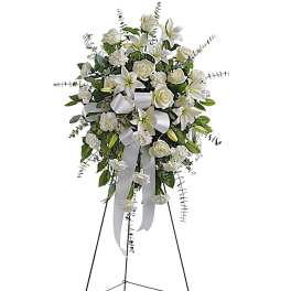 White floral standing spray on an easel with ribbon