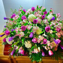 Large pink and purple floral casket spray with roses and alstroemeria