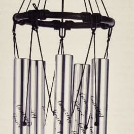 Hanging metal wind chime with silver tubes and an oval "Amazing Grace" tag